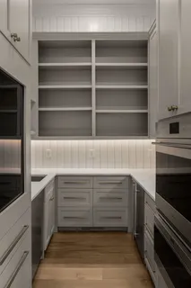 a view of an entryway with wooden floor and a sink