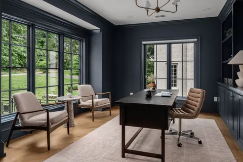 a view of a patio with a table and chairs and a barbeque