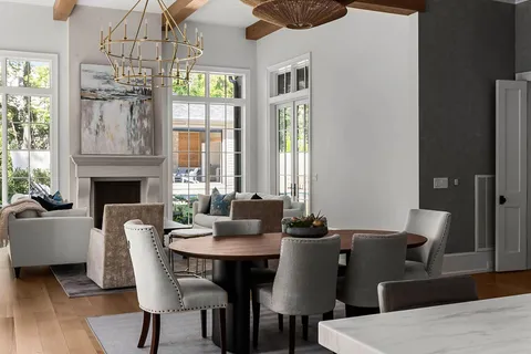 a view of a dining room with furniture a chandelier and wooden floor
