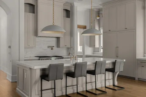 a kitchen with stainless steel appliances a stove a table and chairs
