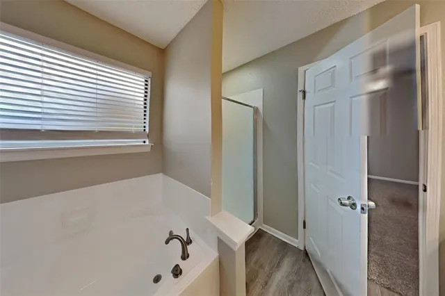 a bathroom with a bathtub and a window
