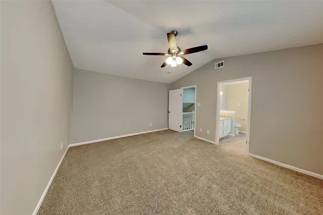 a view of a big room with chandelier fan and windows