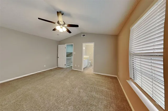 a view of an empty room and a window