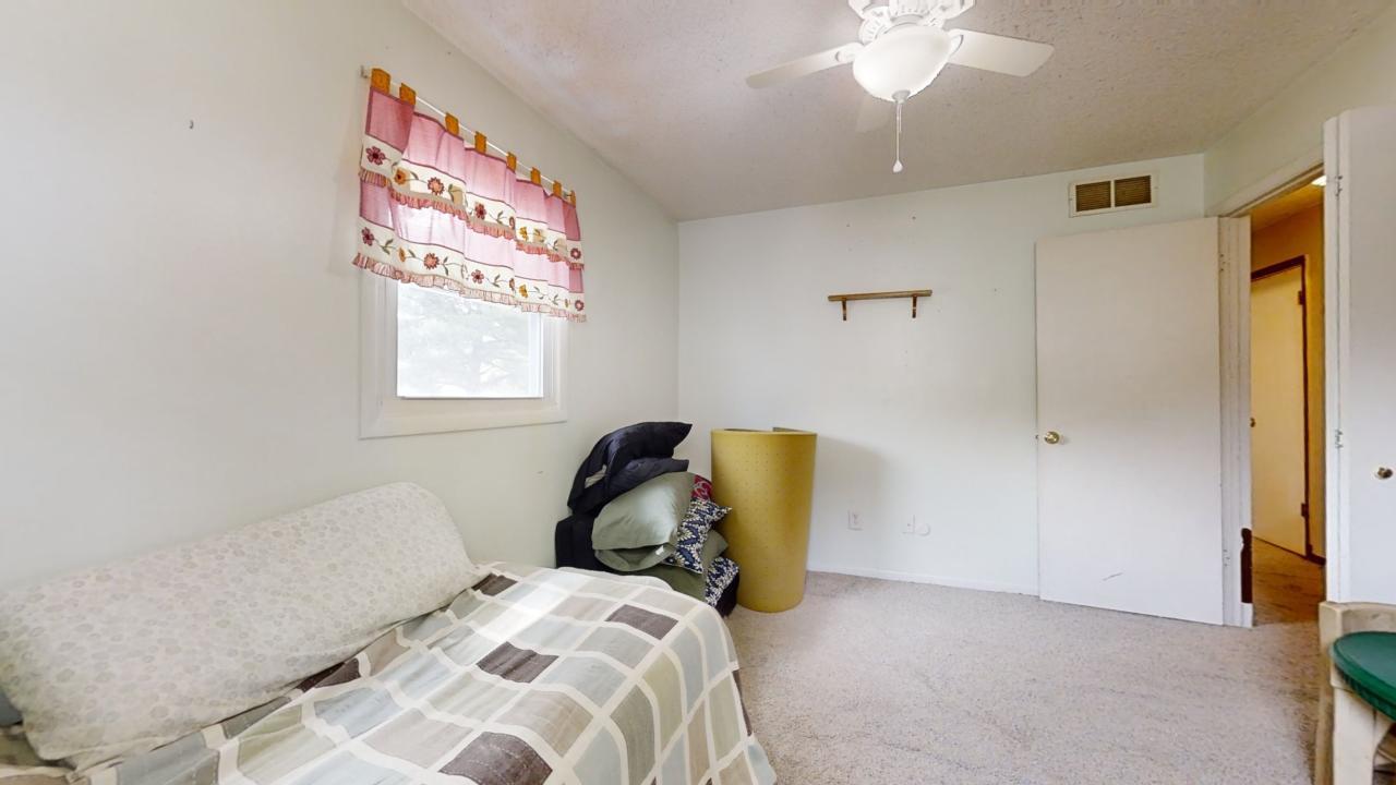 3656 North Meadowlark Drive Decatur, IL 62526 - Photo 11 of 31 a bedroom with a bed and a chandelier