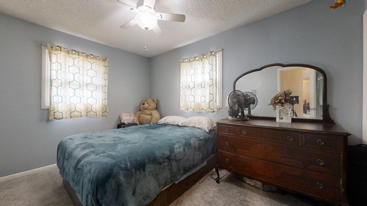3656 North Meadowlark Drive Decatur, IL 62526 - Photo 12 of 31 a bedroom with a bed and a chandelier