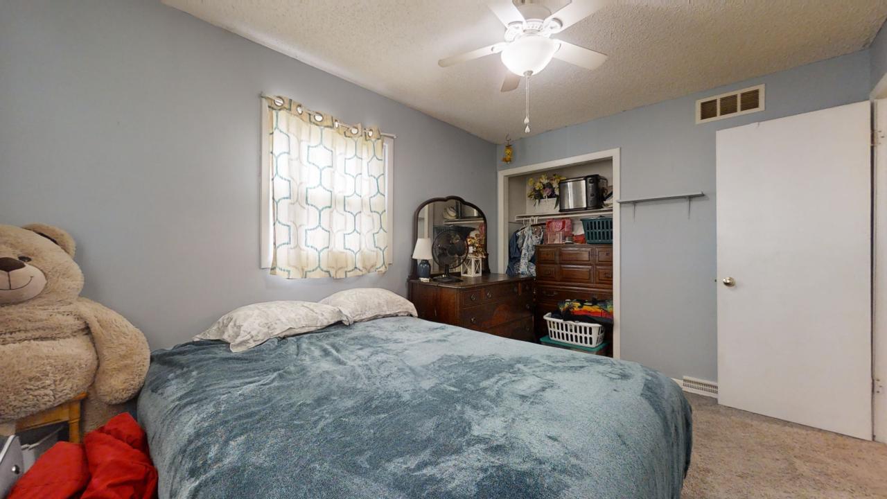 3656 North Meadowlark Drive Decatur, IL 62526 - Photo 13 of 31 a bedroom with a large bed and a tv