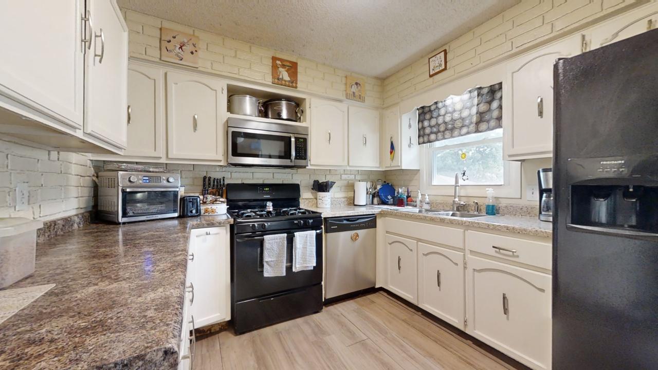 3656 North Meadowlark Drive Decatur, IL 62526 - Photo 8 of 31 a kitchen with stainless steel appliances granite countertop a stove top oven a sink dishwasher and a microwave oven on the blue kitchen countertops