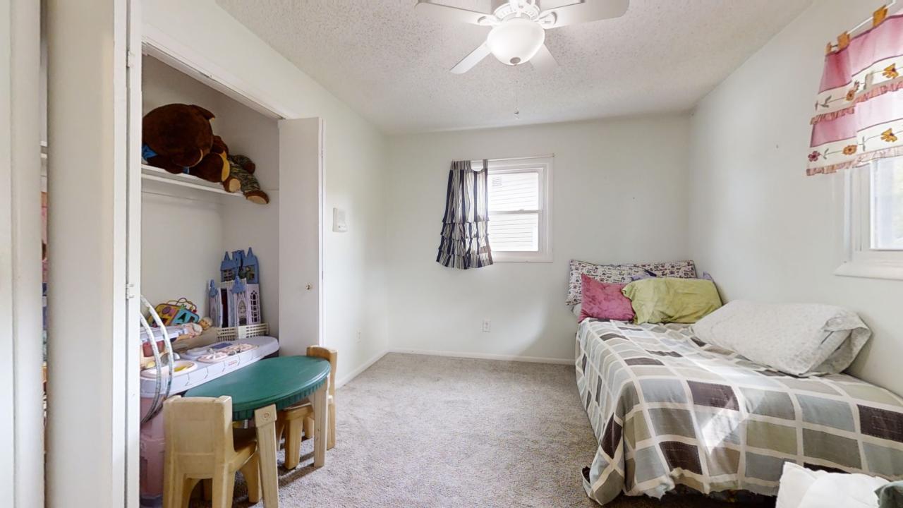 3656 North Meadowlark Drive Decatur, IL 62526 - Photo 10 of 31 a bedroom with a bed and a chandelier