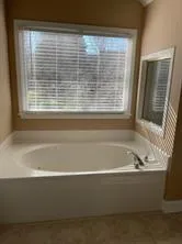 a bathroom with bathtub and shower