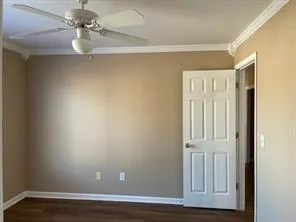 a view of a room with wooden floor and fan