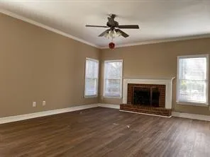 a view of an empty room with a fireplace and a window