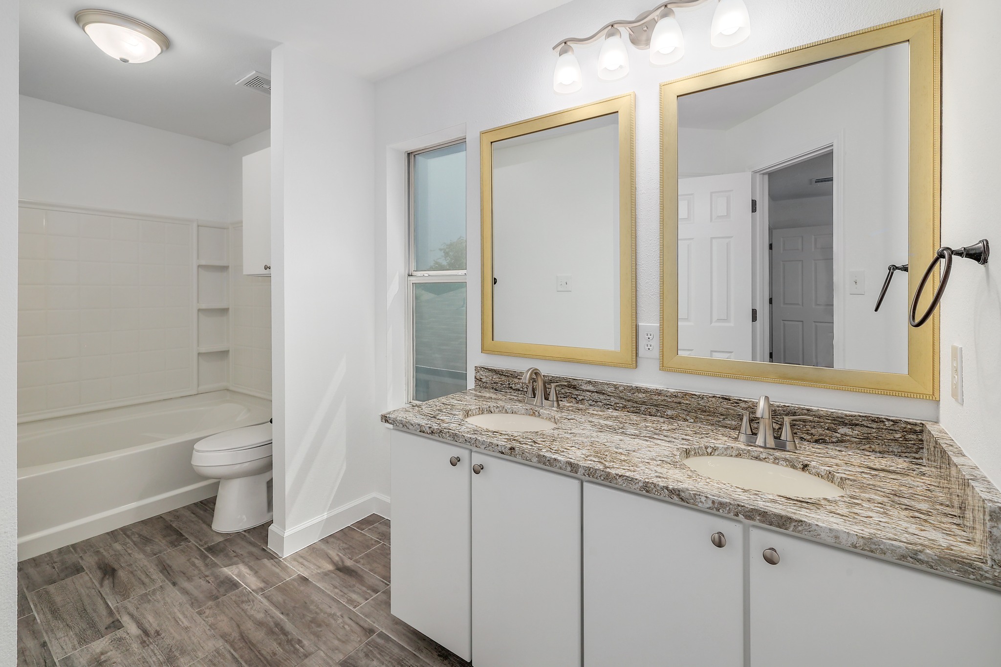 709 Los Robles Road Leander, TX 78641 - Photo 20 of 26 Granite counters and dual vanities provide ample space for daily routines in this well-appointed bathroom.