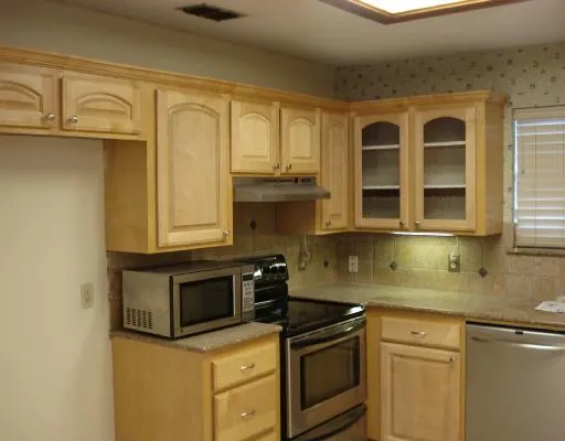 a kitchen with stainless steel appliances granite countertop a sink and a microwave