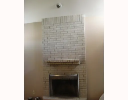 a bathroom with a granite countertop toilet and a sink