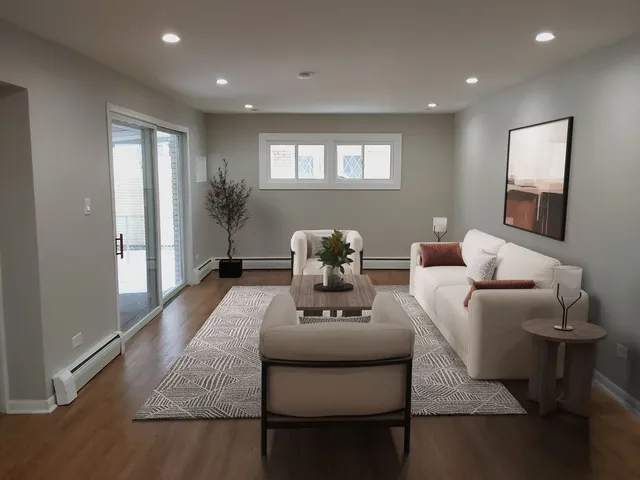 a living room with furniture and a wooden floor