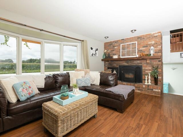 9473 Cemetery Road Winnebago, IL 61088 - Photo 8 of 24 a living room with furniture and a fireplace