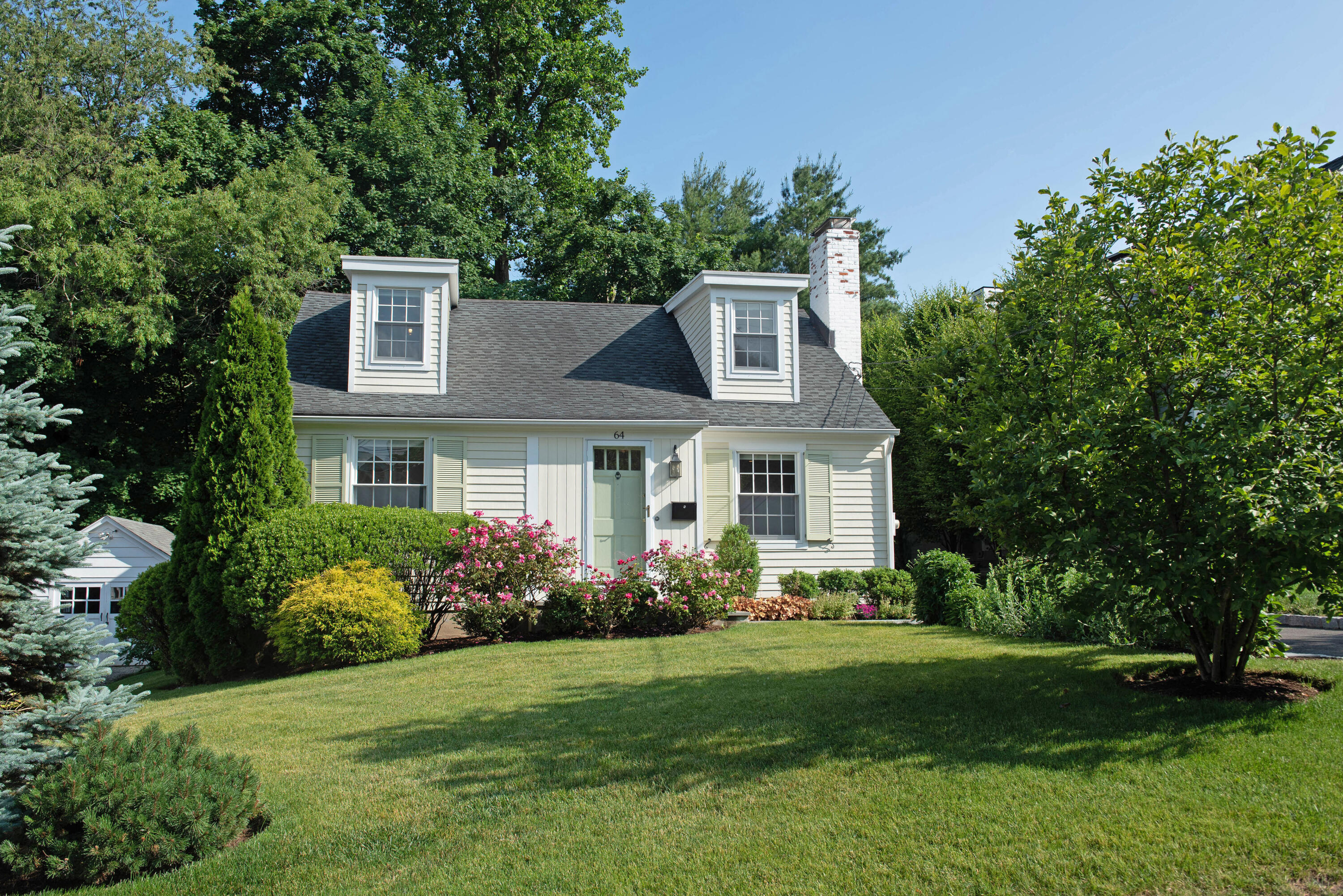 a front view of house with yard and green space