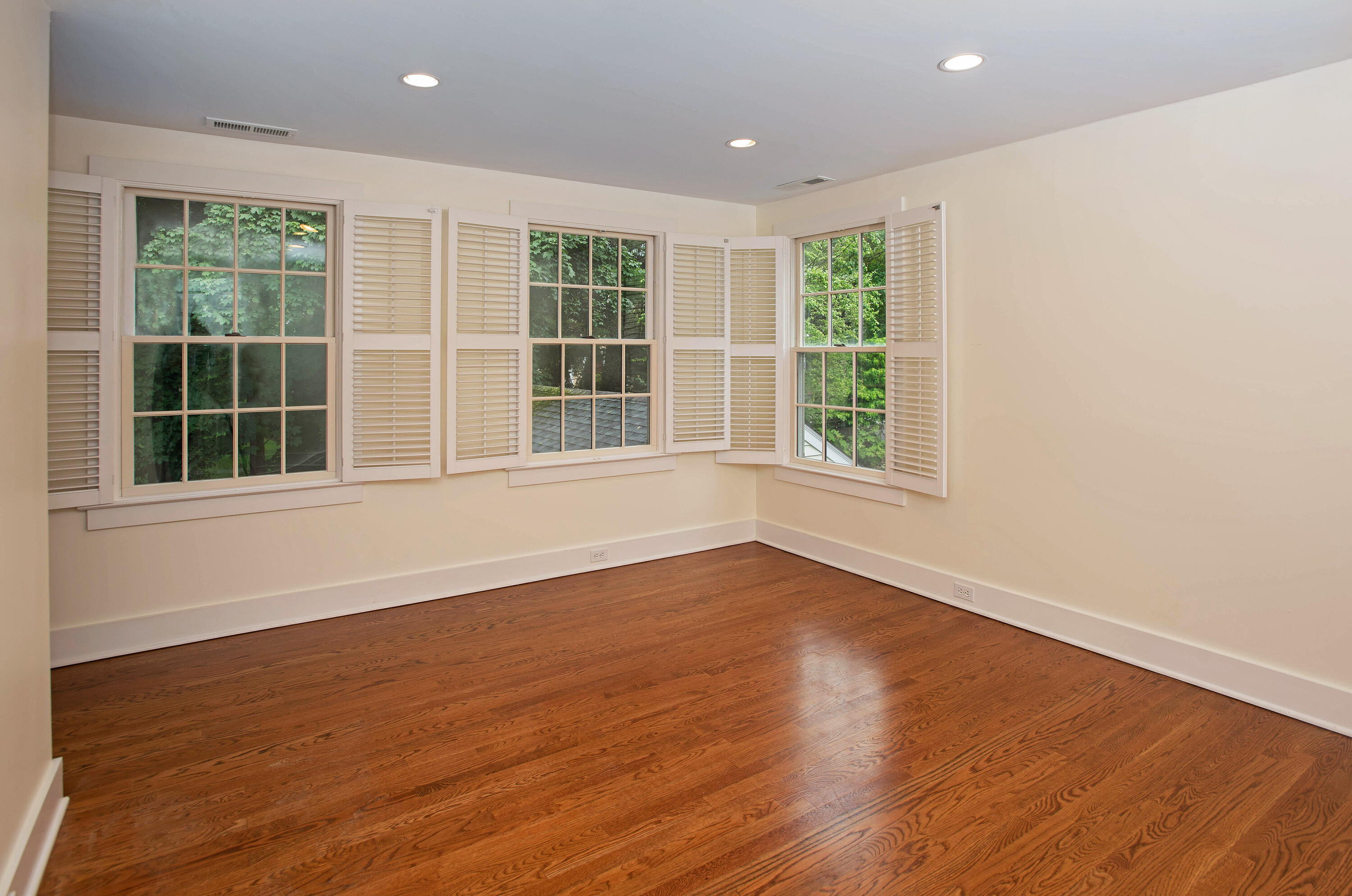 64 Sunrise Avenue New Canaan, CT 06840 - Photo 11 of 22 a view of an empty room with wooden floor and windows