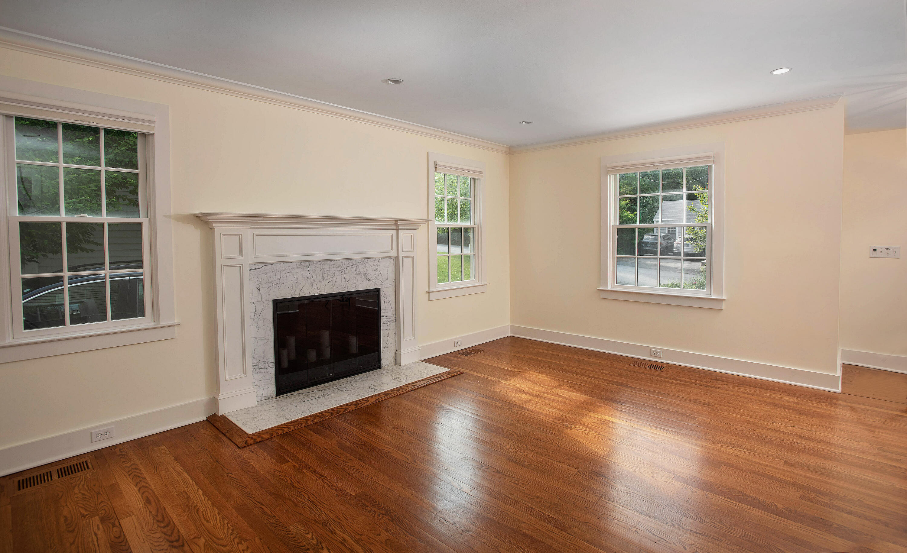 64 Sunrise Avenue New Canaan, CT 06840 - Photo 3 of 22 an empty room with windows and a fireplace