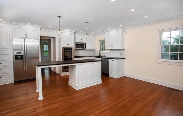 a kitchen with stainless steel appliances a refrigerator and a microwave