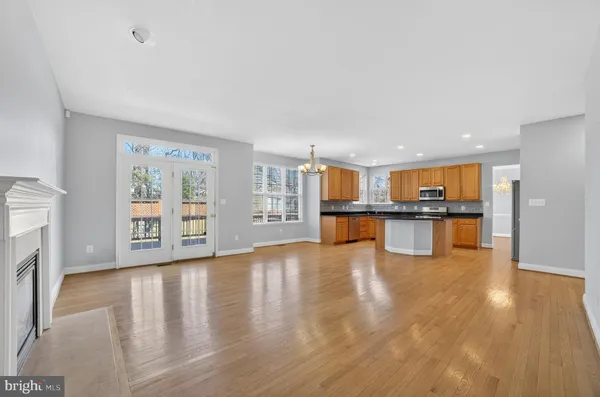 a view of an empty room and wooden floor