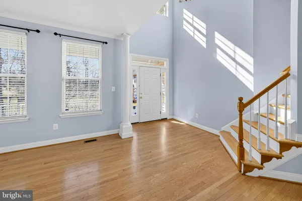a kitchen with stainless steel appliances granite countertop a stove a sink dishwasher and a microwave oven with wooden floor