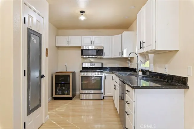a kitchen with stainless steel appliances granite countertop a stove and a microwave