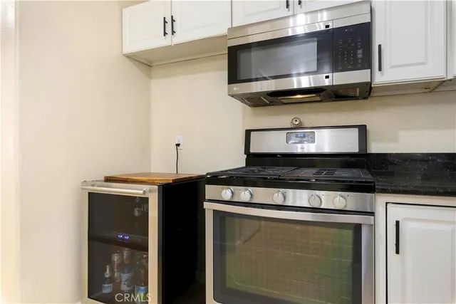 a view of kitchen with granite countertop a sink and a window