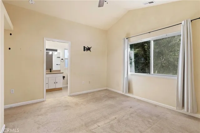 a bathroom with a granite countertop sink toilet a mirror a bathtub and shower