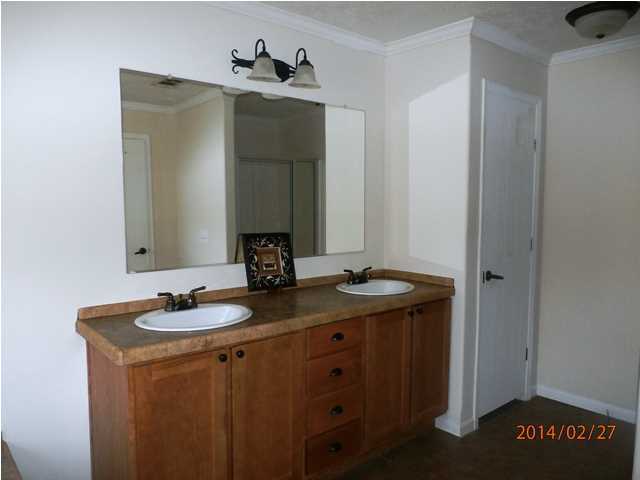 725 Sandy Ramp Road DeFuniak Springs, FL 32433 - Photo 13 of 20 a bathroom with a granite countertop sink and a mirror