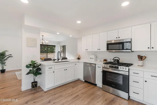 a kitchen with a sink and a refrigerator