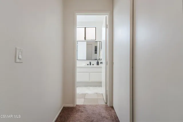 a bathroom with double vanity sinks and a mirror