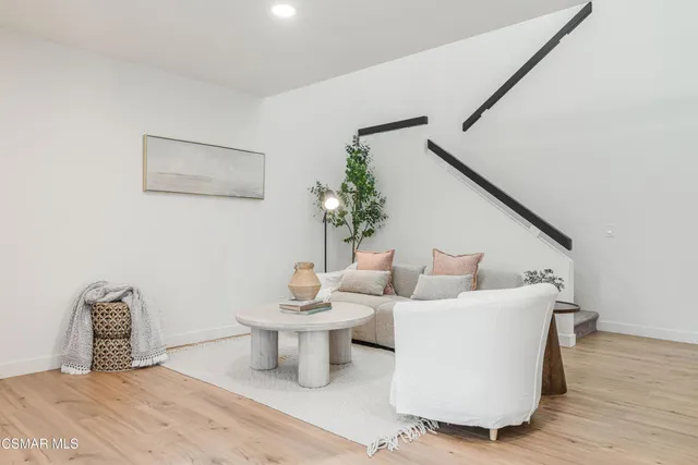 a living room with furniture and a potted plant
