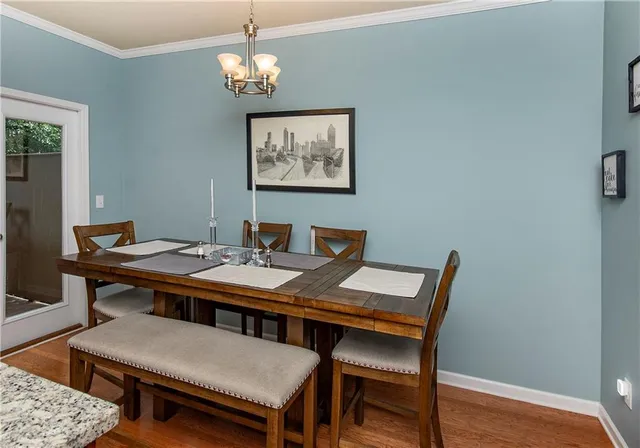 a view of a dining room with a table and chairs