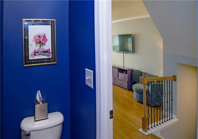 a bedroom with furniture and paintings on the wall