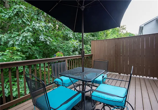 a view of a chair and table on the deck