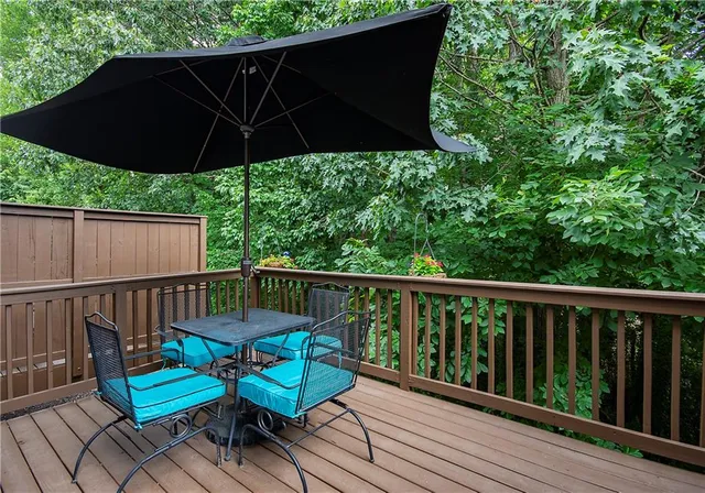 a view of a deck with furniture and wooden floor