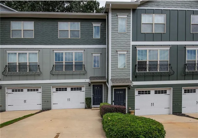 a front view of a building with a garden