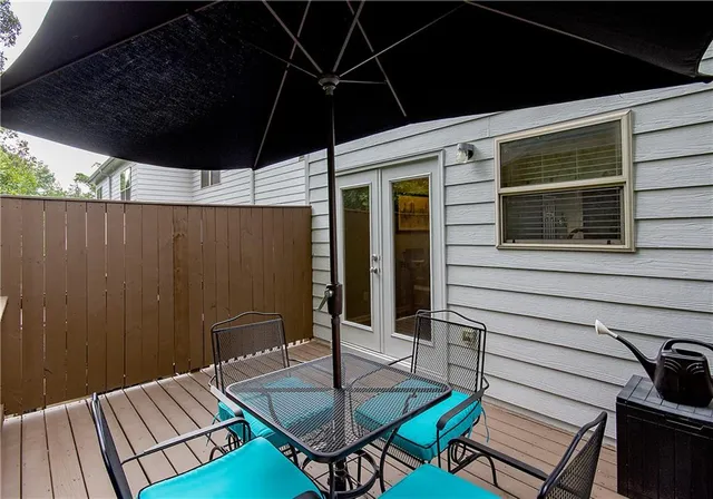 a backyard of a house with table and chairs