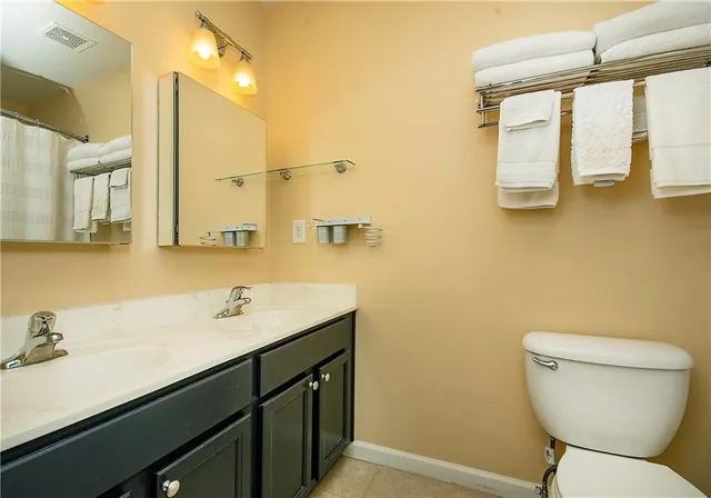 a bathroom with a sink mirror vanity and toilet