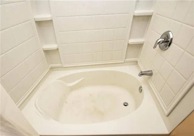 a bath tub sitting next to a white sink