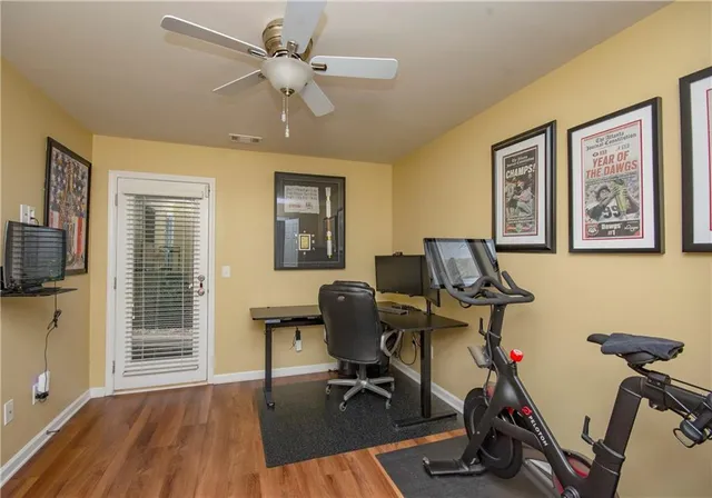 a view of a workspace with furniture and a window
