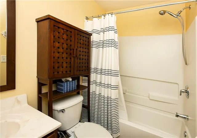 a bathroom with a toilet and shower