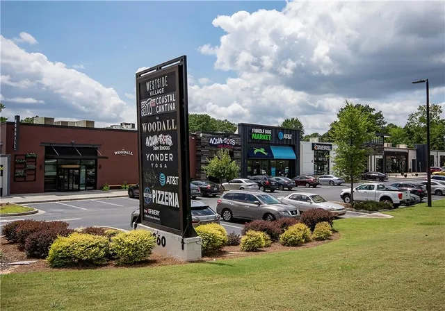a front view of a building with lake view and car parked