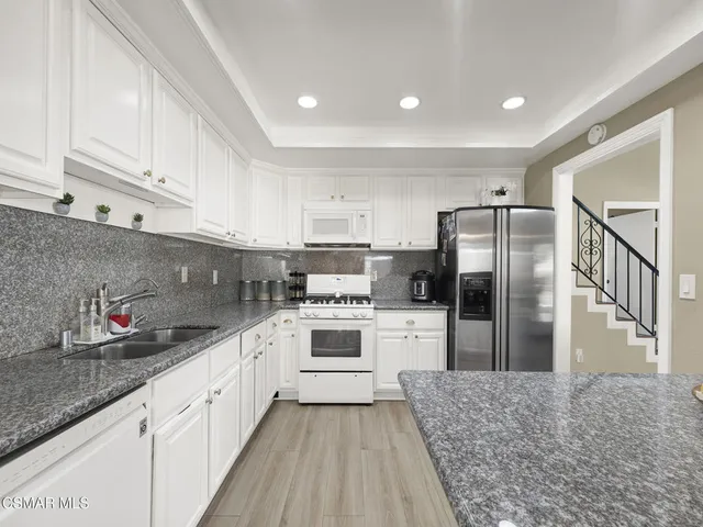 a kitchen with refrigerator and cabinets