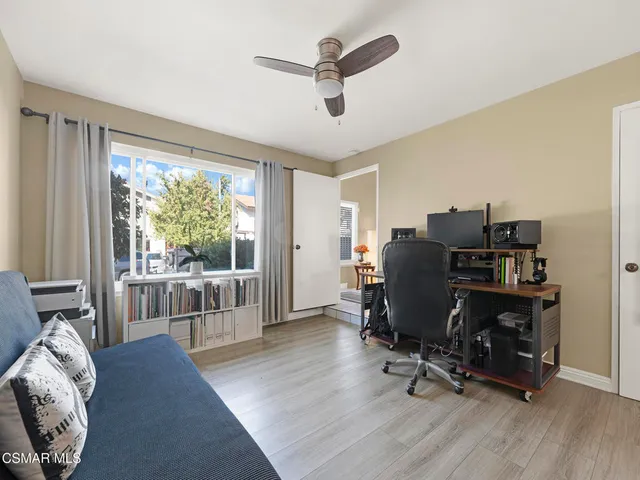 a work room with furniture and a large window