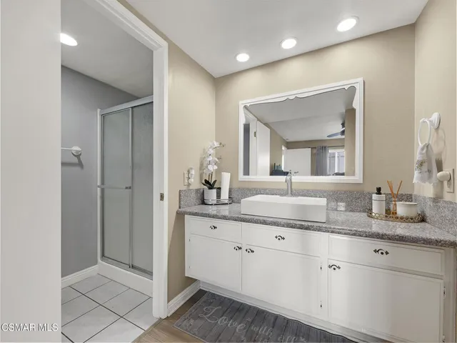 a bathroom with a granite countertop sink mirror and double