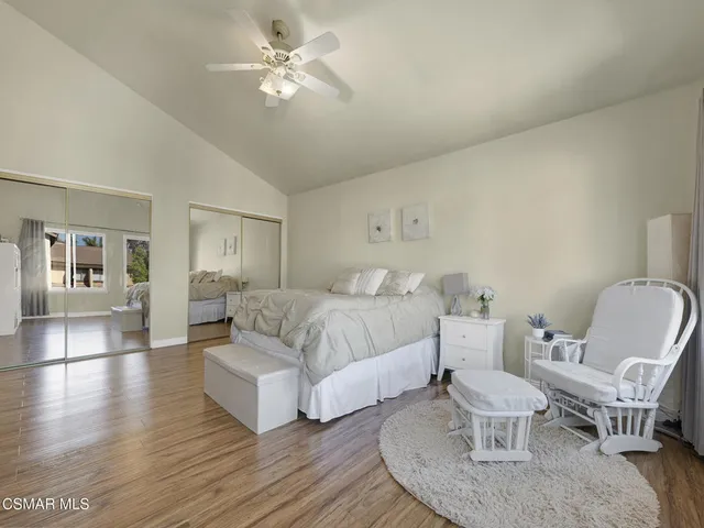 a spacious bedroom with a bed and a chandelier