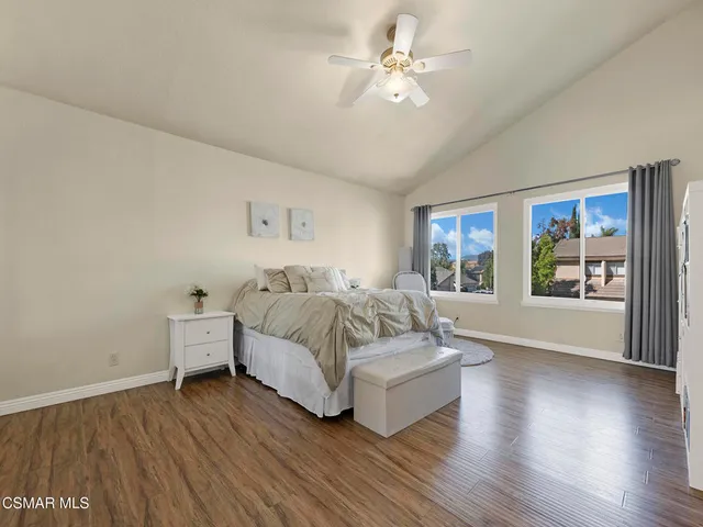 a spacious bedroom with a bed and a chandelier