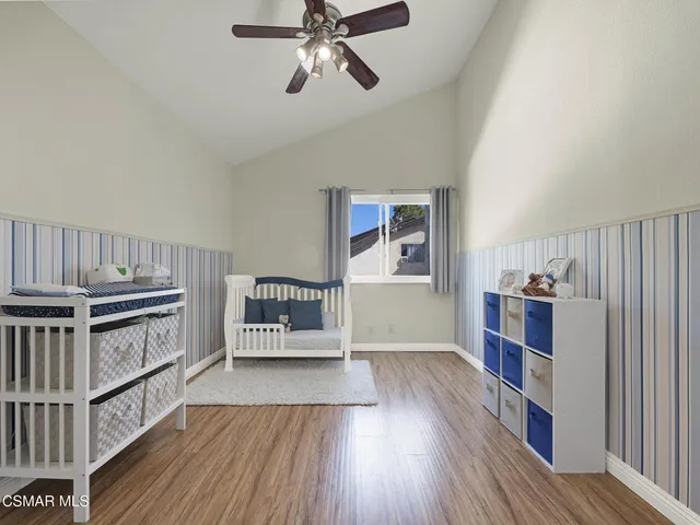 a view of a workspace with furniture and wooden floor